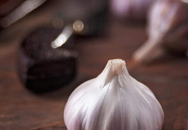 Macro shot of a garlic bulb with a rustic kitchen vibe, perfect for culinary use.
